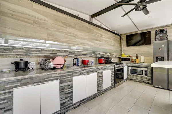 a kitchen with granite countertop lots of counter top space stainless steel appliances and cabinets