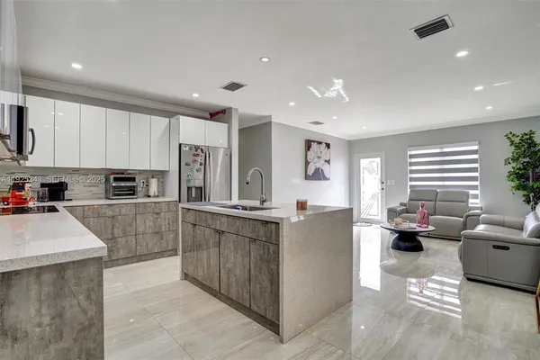 a kitchen with stainless steel appliances kitchen island granite countertop a sink and cabinets