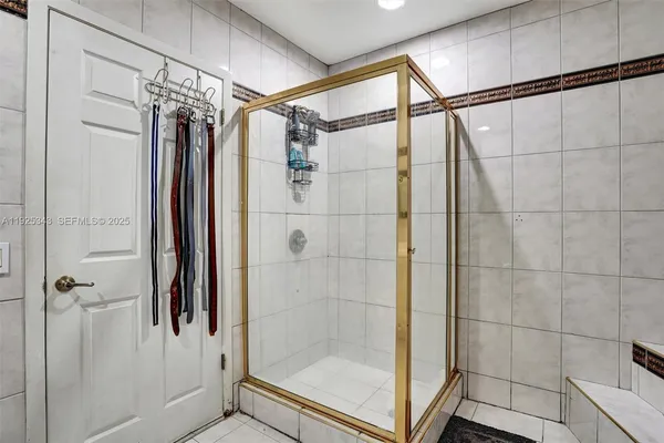 a bathroom with a shower and a glass door
