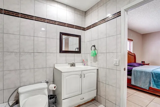 a bedroom with a bed a dresser and mirror