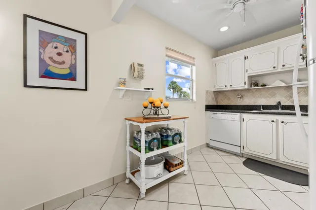 a kitchen with stainless steel appliances cabinets and a window