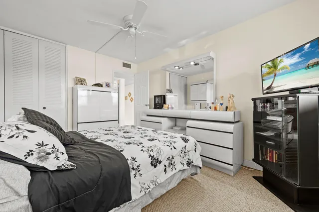 a bedroom with a bed and a flat tv screen