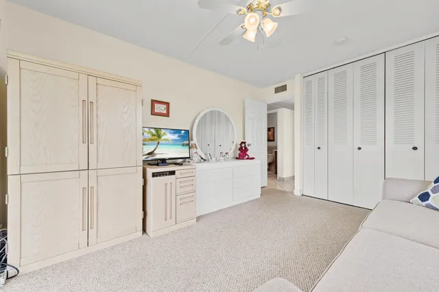 a view of kitchen with refrigerator and cabinets