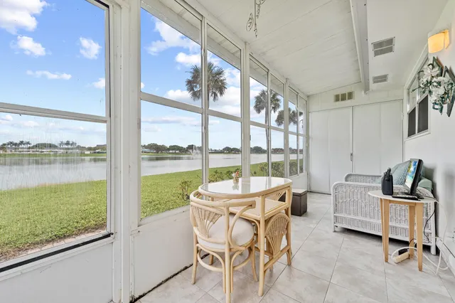 a dining room with furniture and floor to ceiling windows