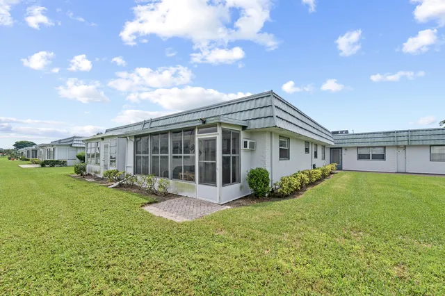 a view of a house with a yard porch and sitting area