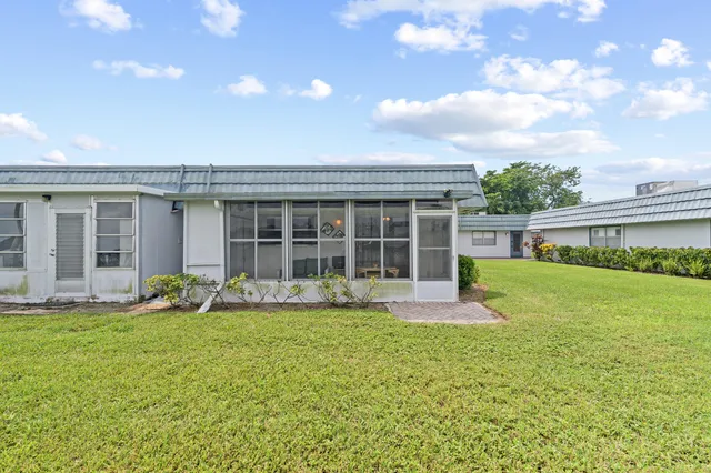 a front view of house with yard and outdoor seating