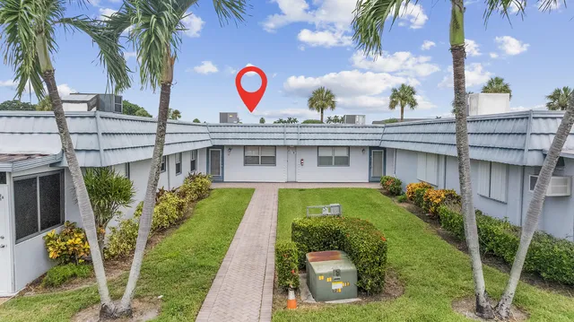 a view of a house with a backyard and a garden