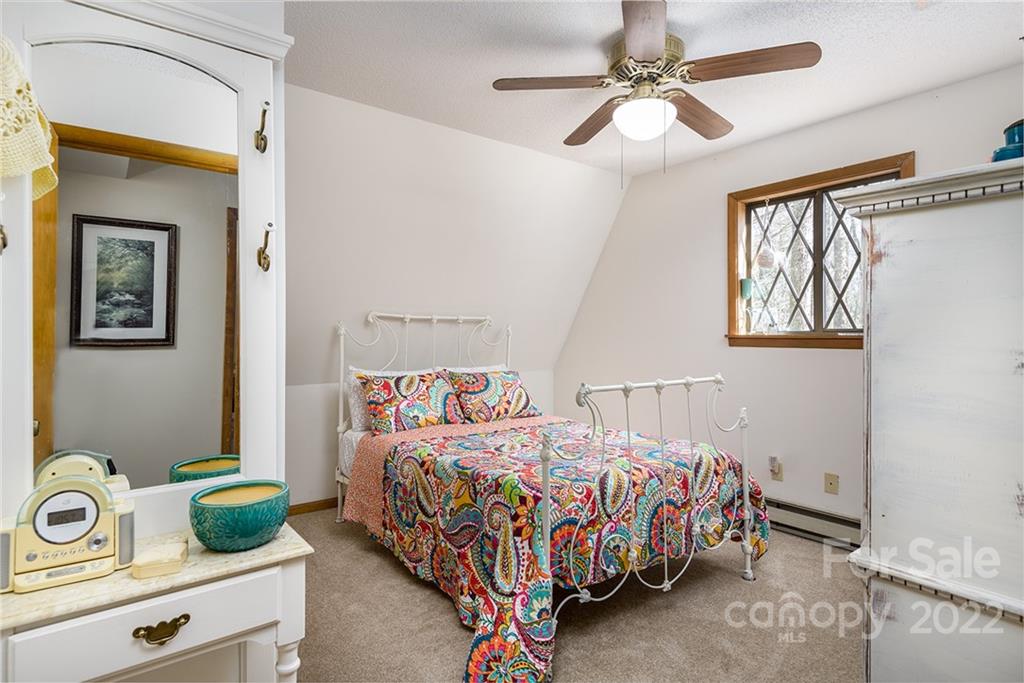 20 Lady Slipper Loop Newland, NC 28657 - Photo 23 of 44 a bedroom with a bed and a chandelier