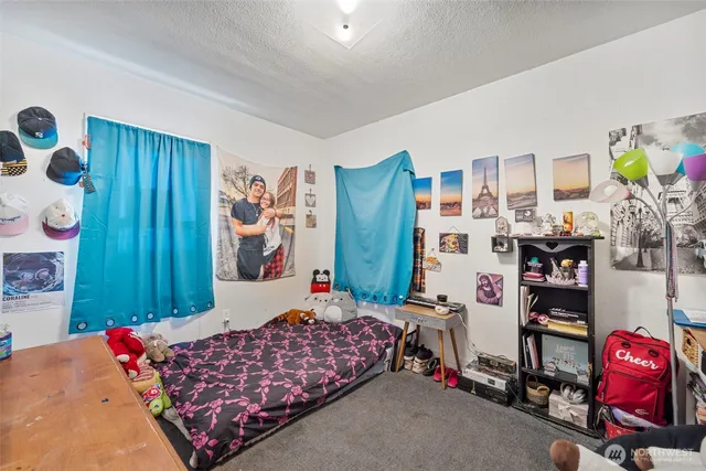 a bedroom with bed and a book shelf