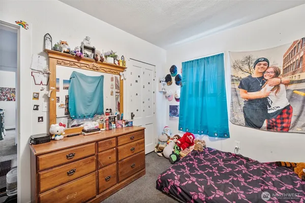 a bed room with a bed mirror and a desk