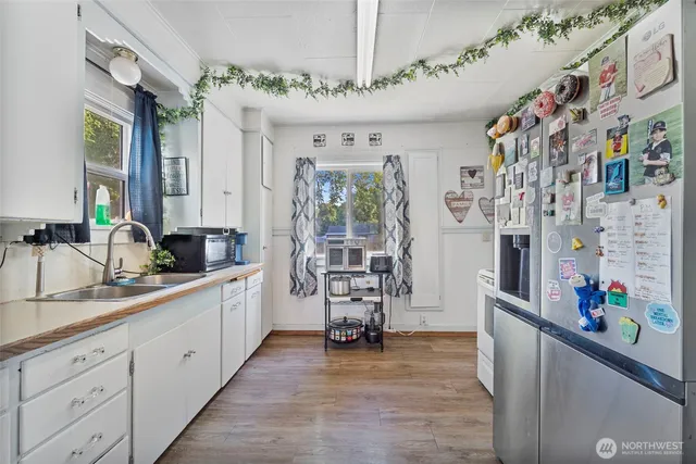 a large white kitchen with stainless steel appliances