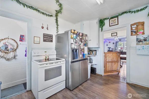 a kitchen with stainless steel appliances granite countertop a refrigerator and a stove top oven