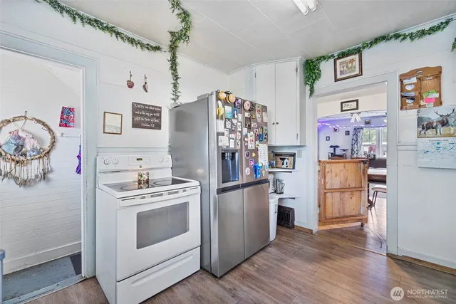 a kitchen with stainless steel appliances granite countertop a refrigerator and a stove top oven