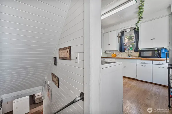 a hallway with cabinets and wooden floor