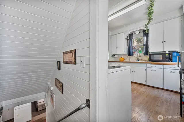 a hallway with cabinets and wooden floor