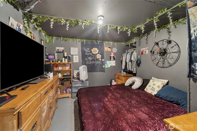 a bedroom with furniture and a flat screen tv