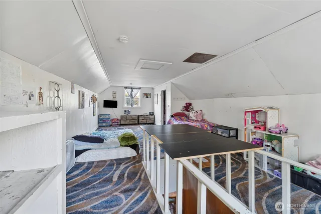 a view of a livingroom with furniture a ceiling fan and wooden floor