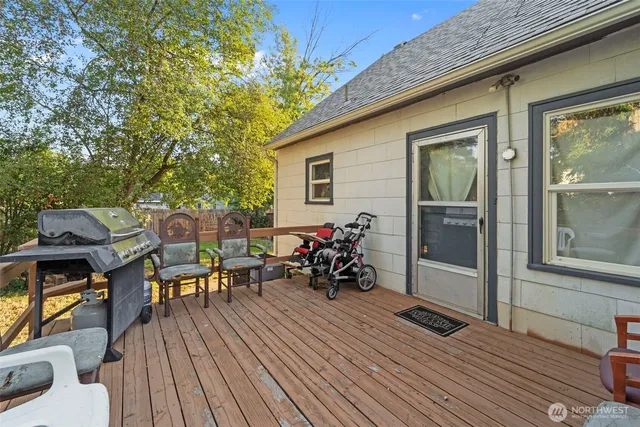 a view of a patio with table and chairs and wooden floor