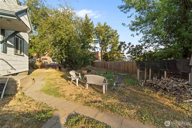 a backyard of a house with table and chairs