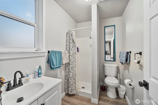 a bathroom with a sink toilet and shower