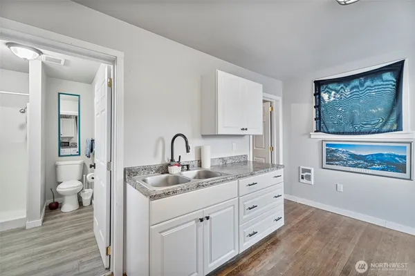 a spacious bathroom with a granite countertop sink mirror and toilet