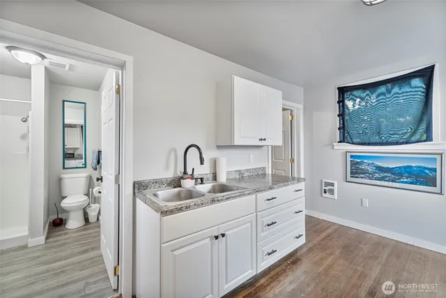 a spacious bathroom with a granite countertop sink mirror and toilet