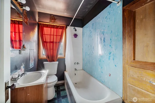 a bathroom with a tub a sink and a window