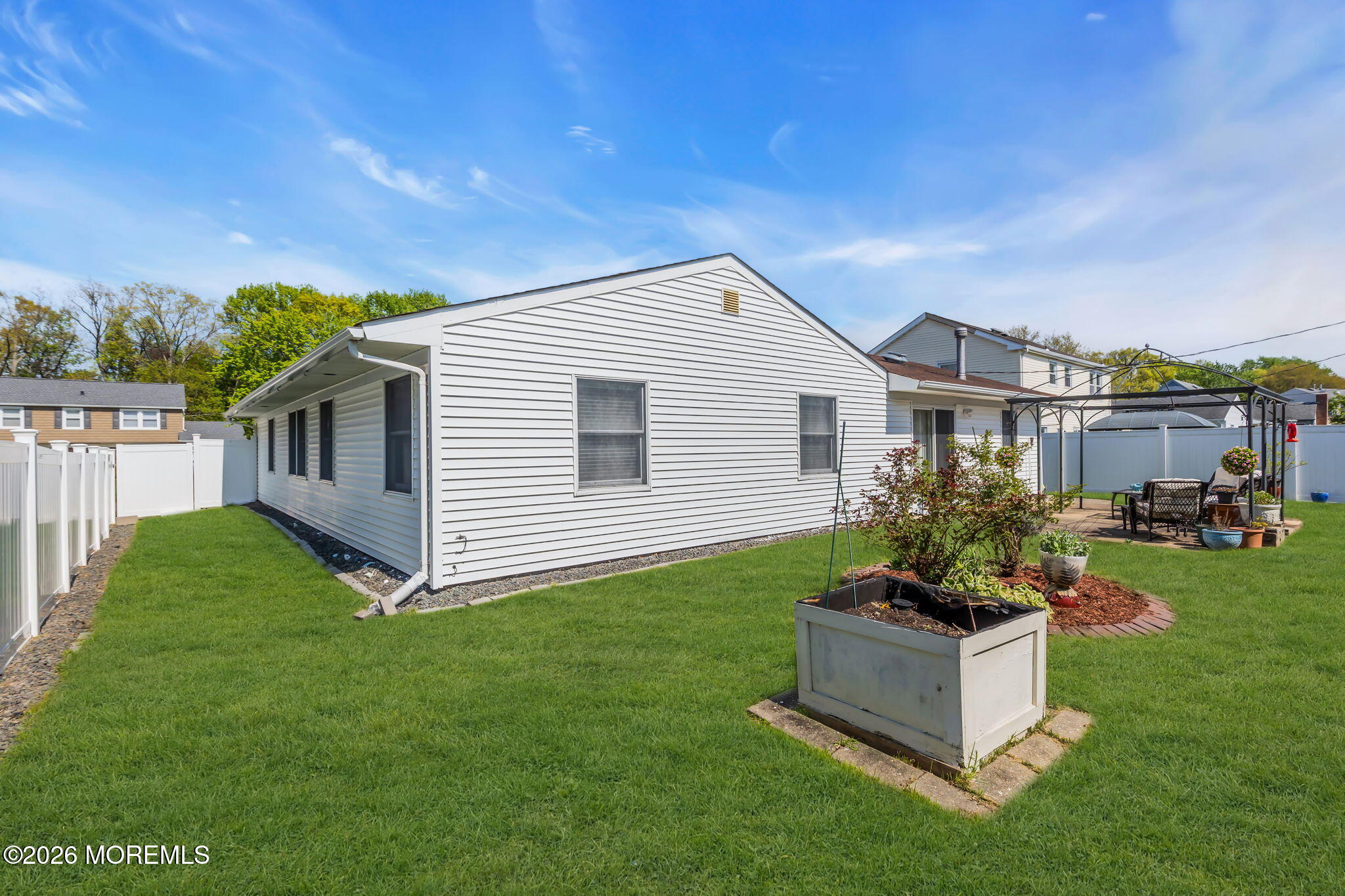 101 Andover Lane Matawan, NJ 07747 - Photo 50 of 51 a white house with a yard and plants