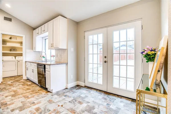 a view of kitchen with wooden floor and electronic appliances