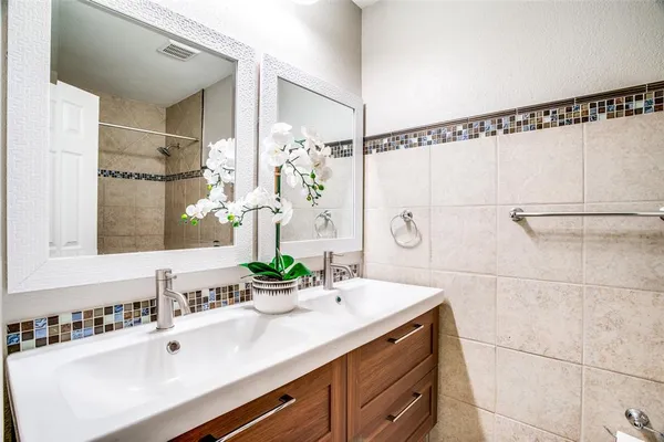 a bathroom with a double vanity sink and mirror