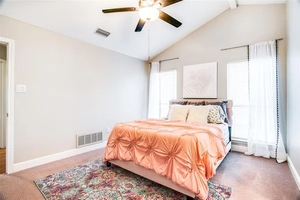 a bedroom with bed and a window