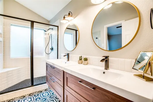 a bathroom with a double vanity sink and a mirror