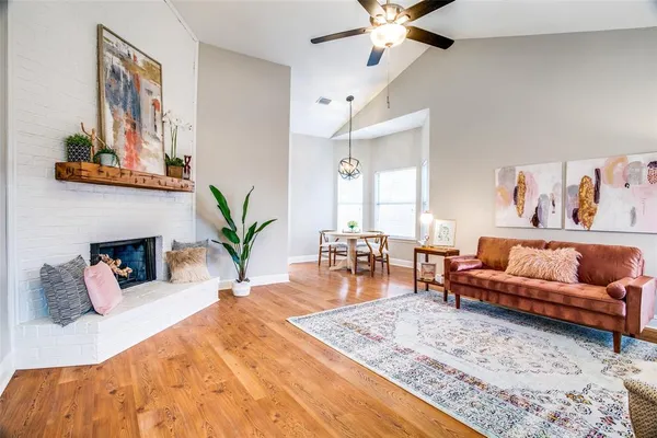 a living room with furniture flowerpot and wooden floor