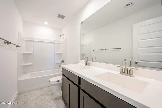 a bathroom with a sink a toilet a shower and a mirror