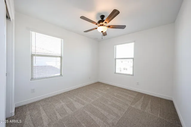 a view of a livingroom with a ceiling fan and window