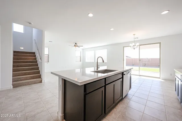 a kitchen with a sink and a stove top oven