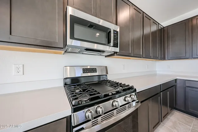 a kitchen with stainless steel appliances granite countertop a stove and a microwave