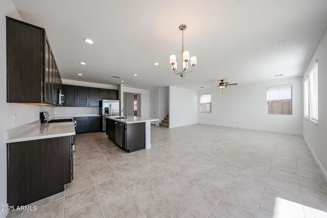 a view of a kitchen with a sink stainless steel appliances and cabinets