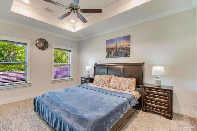 a bedroom with a bed and a chandelier