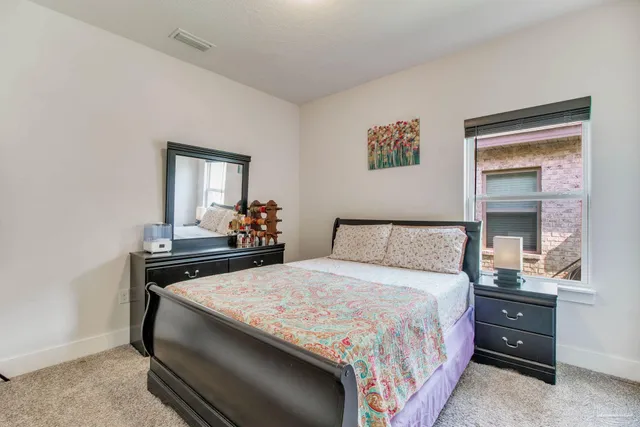 a bedroom with a bed and a table in it