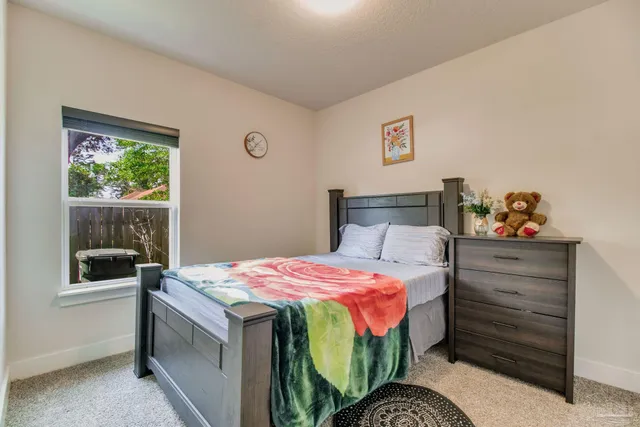 a bedroom with a bed and a window