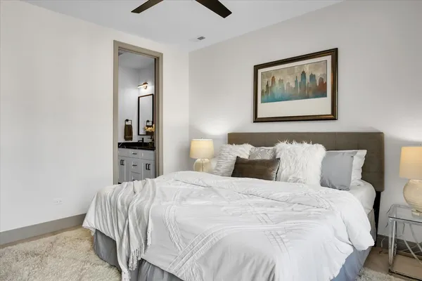 a bedroom with bed and painting on the wall