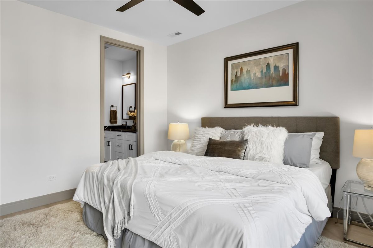 4235 South Champlain Avenue, Unit 1N Chicago, IL 60653 - Photo 11 of 26 a bedroom with bed and painting on the wall