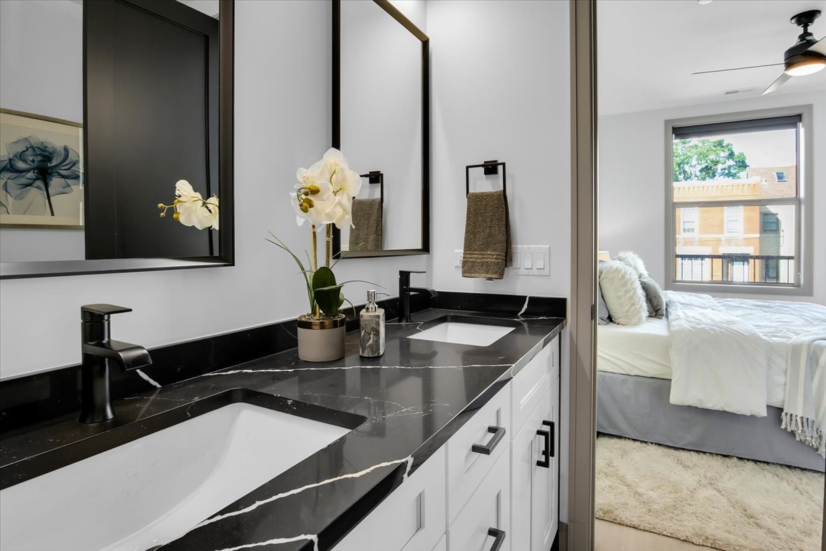 4235 South Champlain Avenue, Unit 1N Chicago, IL 60653 - Photo 13 of 26 a bathroom with a granite countertop sink and a mirror