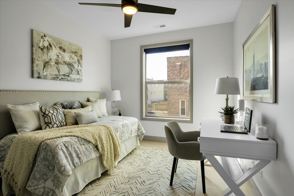 4235 South Champlain Avenue, Unit 1N Chicago, IL 60653 - Photo 15 of 26 a bed room with a bed and a chair