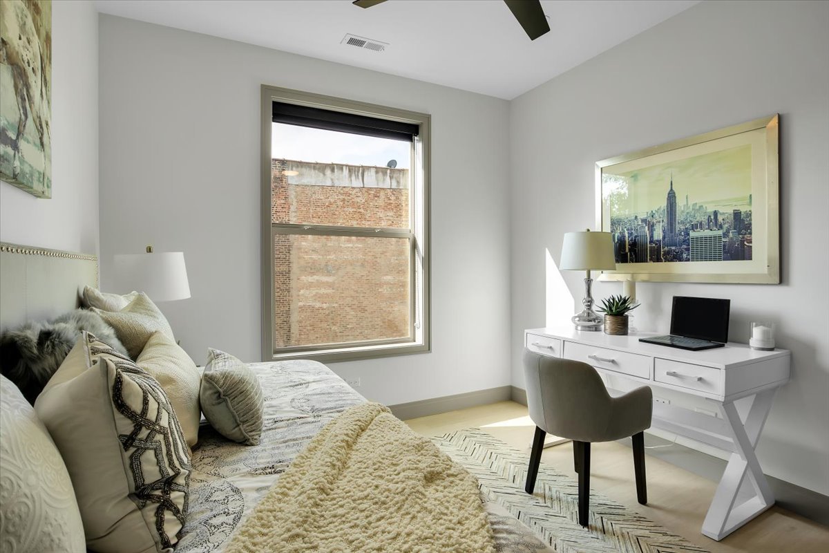 4235 South Champlain Avenue, Unit 1N Chicago, IL 60653 - Photo 18 of 26 a bedroom with a bed and a fireplace