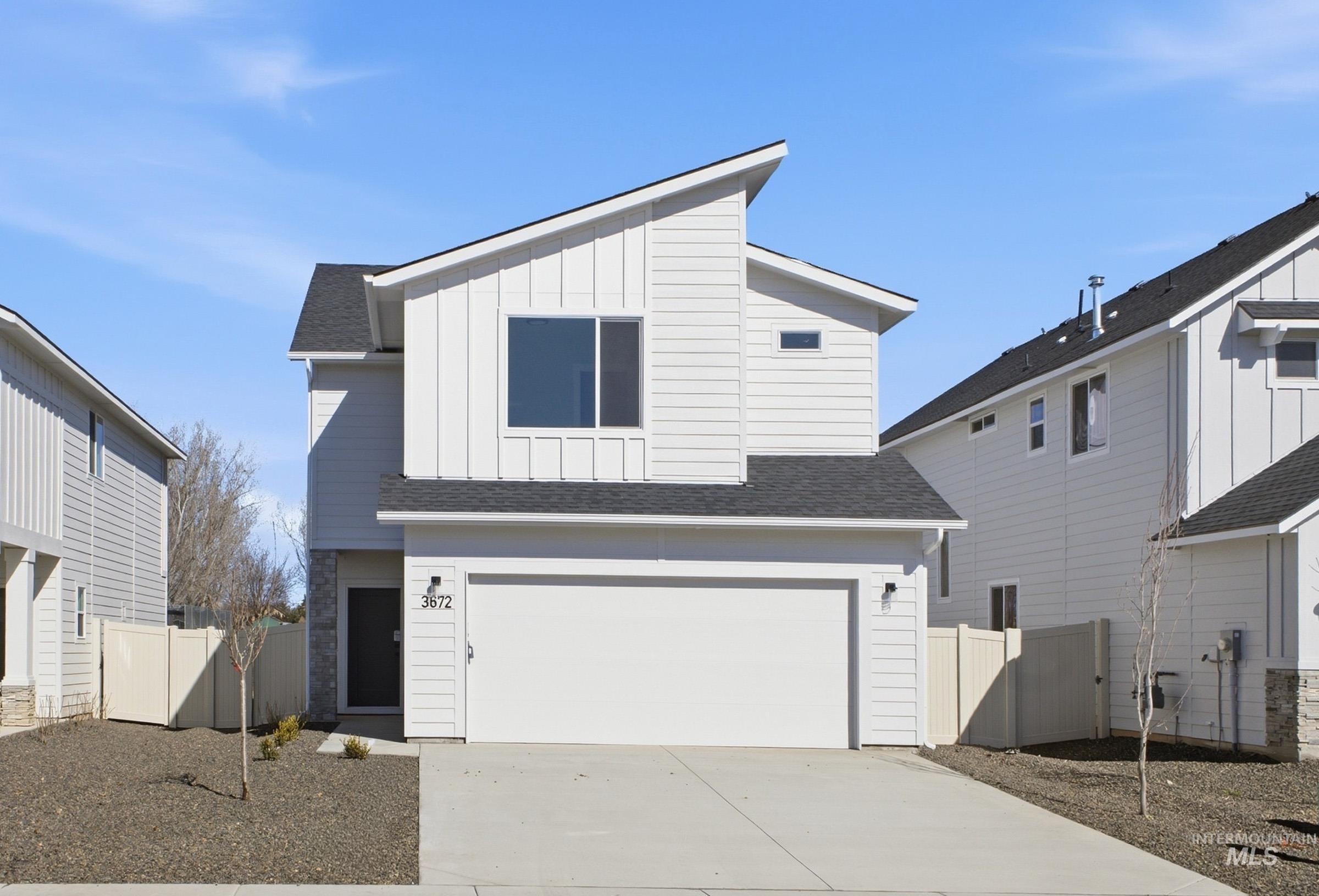 3672 West Dover Drive Meridian, ID 83642 - Photo 1 of 1 View of front facade featuring roof with shingles, driveway, a garage, and board and batten siding