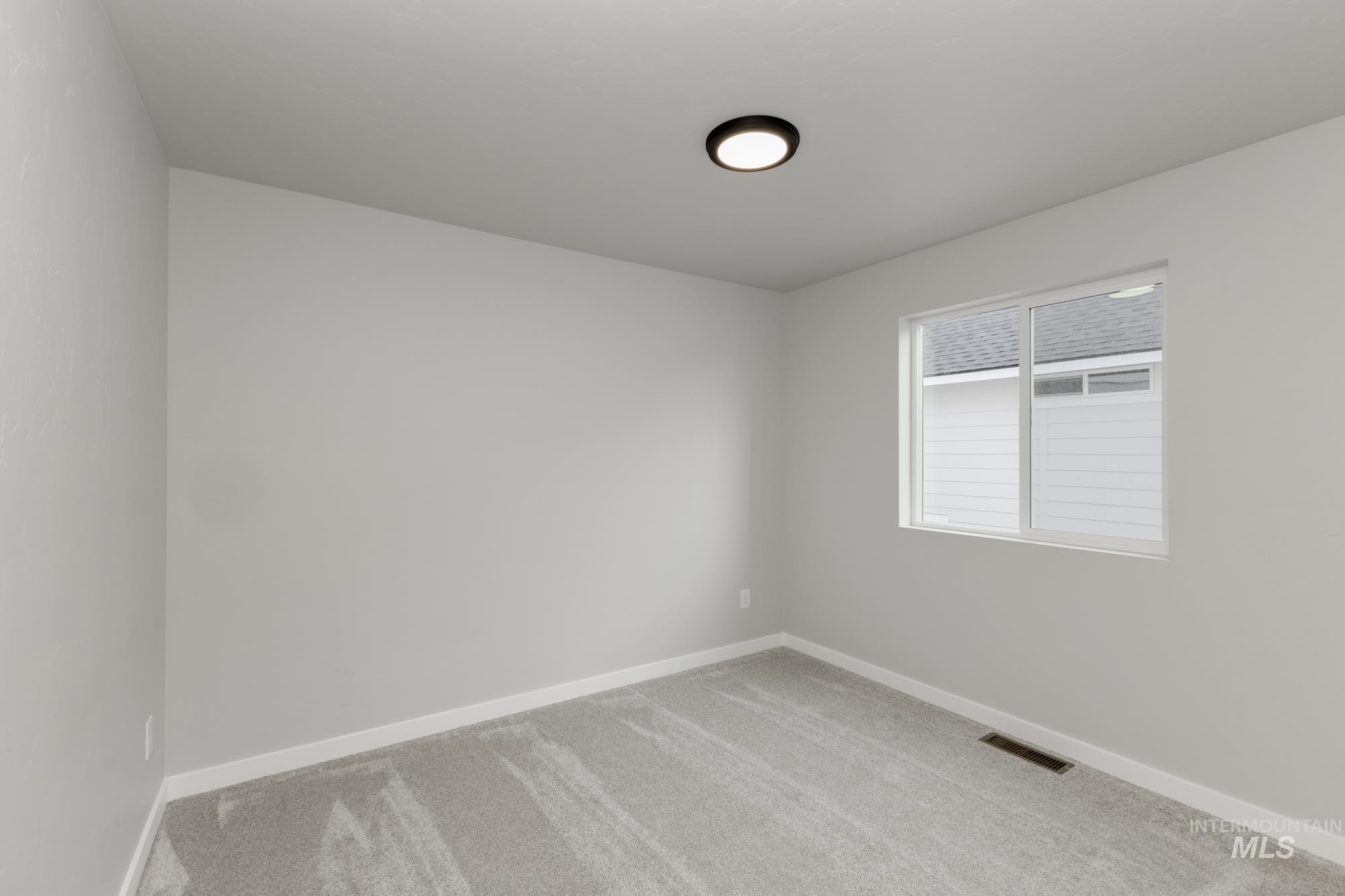 3672 West Dover Drive Meridian, ID 83642 - Photo 13 of 23 Carpeted empty room featuring baseboards