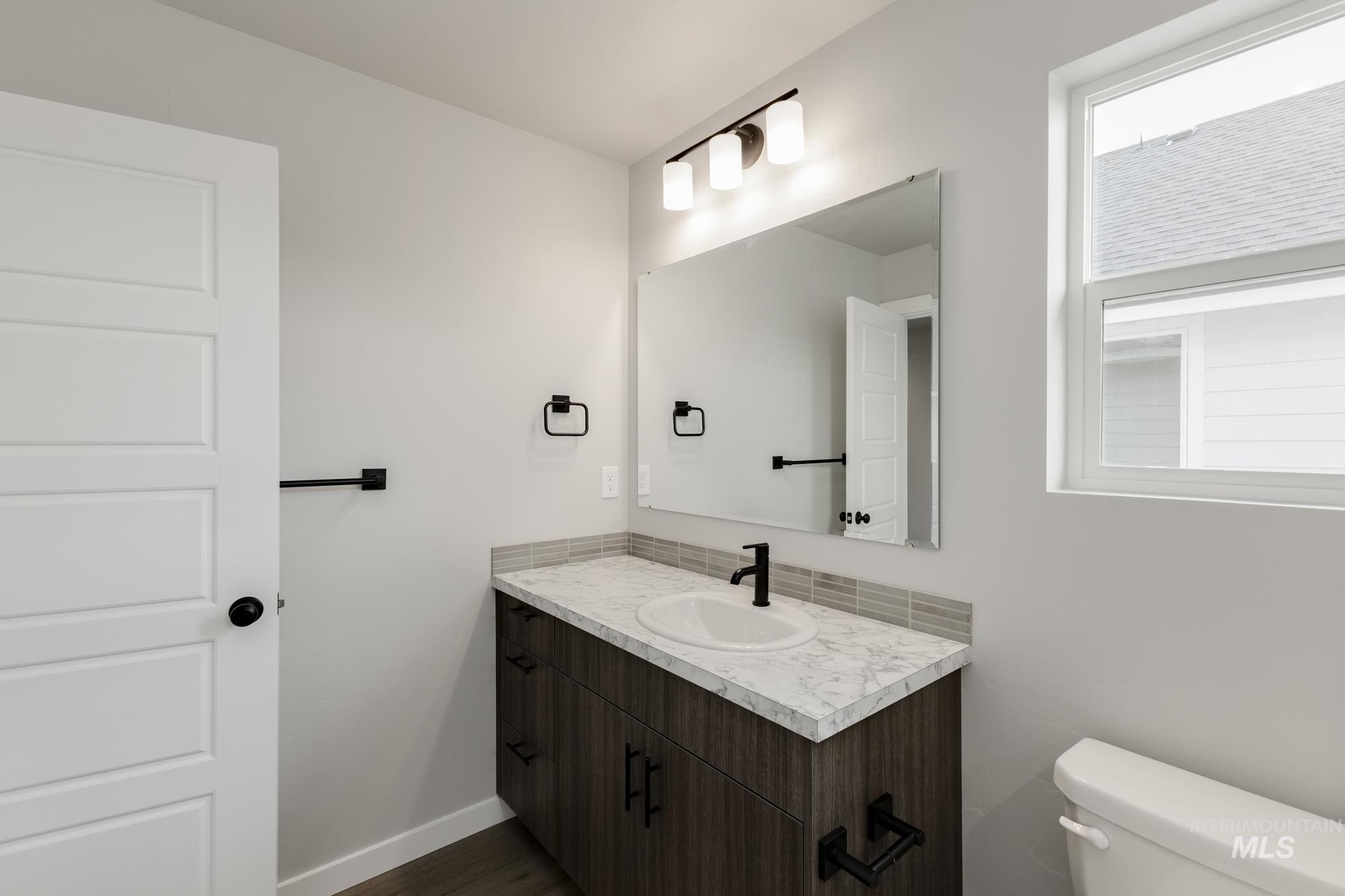 3672 West Dover Drive Meridian, ID 83642 - Photo 15 of 23 Half bathroom with vanity and dark wood-type flooring