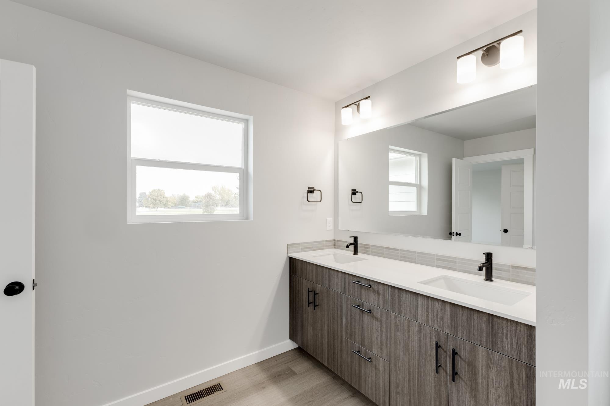 3672 West Dover Drive Meridian, ID 83642 - Photo 20 of 23 Full bath with double vanity and light wood-style floors
